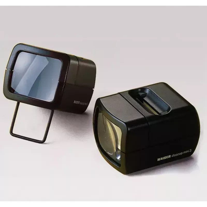 Skaidrių projektorius KAISER 2010 – kompaktiškas 3× didinimas, 75×105×60 mm, 1,5 V baterija