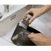 Joseph Joseph Palm Scrub Grey indų šepetys su integruotu muilo dozatoriumi