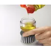 Joseph Joseph Palm Scrub Grey indų šepetys su integruotu muilo dozatoriumi