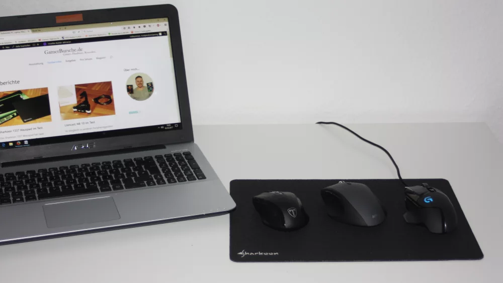 Laptop with several mice on a mouse pad